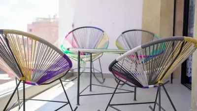 three chairs and a table in a room at Modern 3-Bedroom apartment with Balcony-Central Gueliz Marrakech in Marrakech