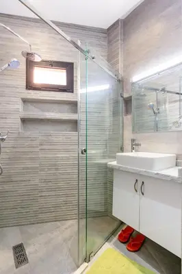 a bathroom with a glass shower and a sink at Modern 3-Bedroom apartment with Balcony-Central Gueliz Marrakech in Marrakech