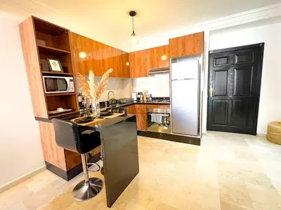 a kitchen with a black counter and a refrigerator at Apartment for Rent Luxury Stay Near to Jemaa el-Fnaa in Marrakech
