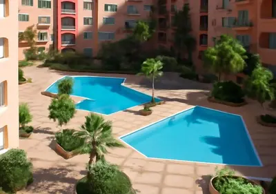 an overhead view of two swimming pools in a building at Marrakech Appart in Marrakech