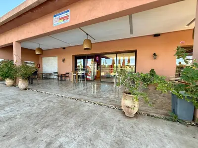a building with potted plants in front of it at Beach Mama Waky Marrakech Appartement Premium Piscine & Vue Atlas in Marrakech