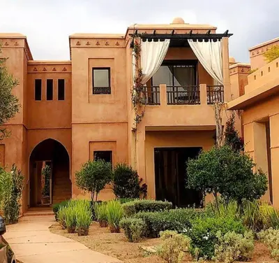 a large building with a balcony and a porch at Beach Mama Waky Marrakech Appartement Premium Piscine & Vue Atlas in Marrakech