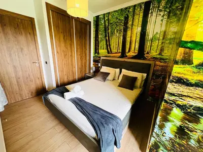 a bedroom with a bed with a painting on the wall at Splendido appartamento a Gueliz in Marrakech