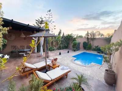 a patio with chairs and a swimming pool at Villa brek in Marrakech