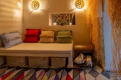 a bed in a room with colorful pillows on it at Riad Bed & Breakfast Comptoir du Pacha in Marrakech