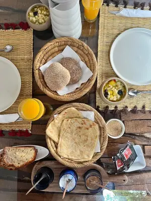 a table with baskets of food and plates of food at Riad Bed & Breakfast Comptoir du Pacha in Marrakech
