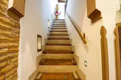 a staircase in a building with a stone wall at Riad Bed & Breakfast Comptoir du Pacha in Marrakech