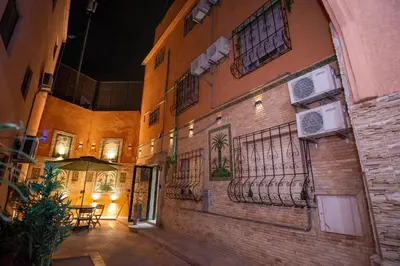 a brick building with a balcony on the side of it at Riad QAYS in Marrakech