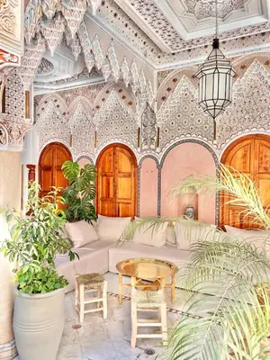a living room with a white couch and a table at Riad Azad & Spa in Marrakech