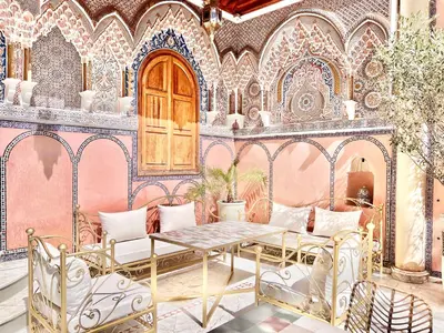 a patio with a table and chairs in a building at Riad Azad & Spa in Marrakech