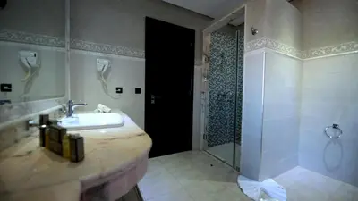 a bathroom with a sink and a shower at El Olivar Palace Marrakech All Inclusive, Aquapark & SPA in Marrakech