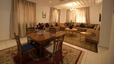 a living room with a table and a couch at El Olivar Palace Marrakech All Inclusive, Aquapark & SPA in Marrakech