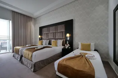a hotel room with two beds and a large window at El Olivar Palace Marrakech All Inclusive, Aquapark & SPA in Marrakech