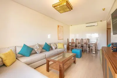 a living room with a couch and a table at Résidence golfique, jardin, piscine in Marrakech
