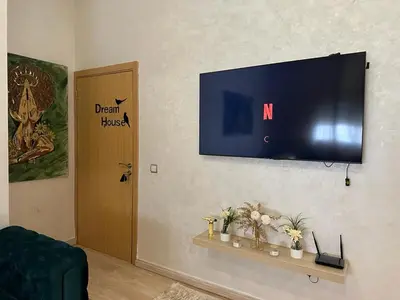 a flat screen tv hanging on a wall at Appartement propre au centre de Marrakech in Marrakech
