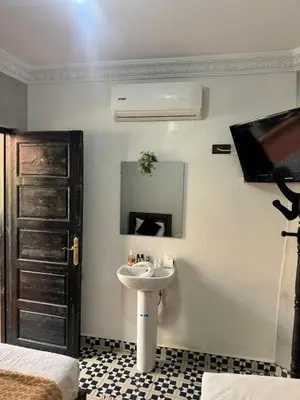 a bathroom with a sink and a mirror at Riad Douja in Marrakech