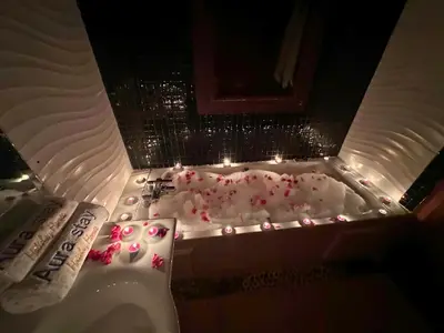 a bathroom with a tub with pink flowers in it at Résidence Soltana, Marrakech in Marrakech