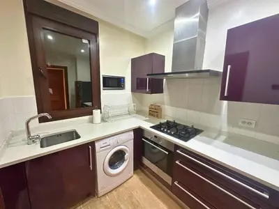 a kitchen with a sink and a washing machine at Résidence Soltana, Marrakech in Marrakech