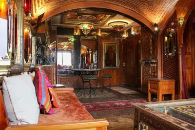 a woman sitting on a bench in a train room at Atypical functional flat Gueliz close Garden Harti in Marrakech