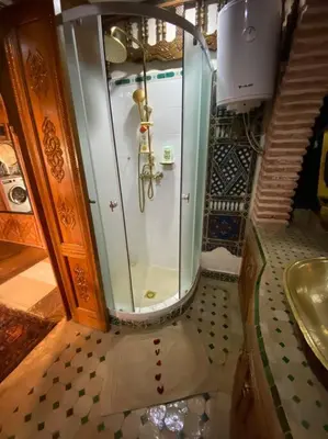a shower with a glass door and a sink at Atypical functional flat Gueliz close Garden Harti in Marrakech