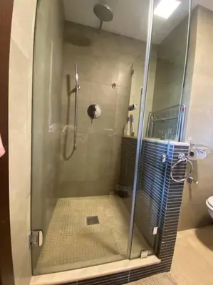 a shower with a glass door in a bathroom at Superbe pied à terre sur Majorelle in Marrakech