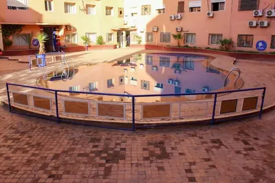 a large swimming pool in the middle of a courtyard at SUBLIME APPARTEMENT 2 CHAMBRES AU COEUR DE GUELIZ in Marrakech
