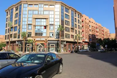 a black car parked in front of a large building at SUBLIME APPARTEMENT 2 CHAMBRES AU COEUR DE GUELIZ in Marrakech