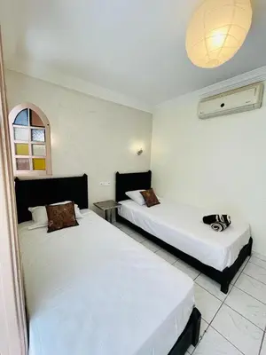 a room with two beds in a room at full home pool terrasse résidence alqaria assiyahiya in Marrakech