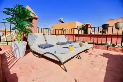 a white chair sitting on top of a patio at full home pool terrasse résidence alqaria assiyahiya in Marrakech