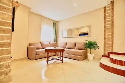 a living room with a couch and a table at full home pool terrasse résidence alqaria assiyahiya in Marrakech