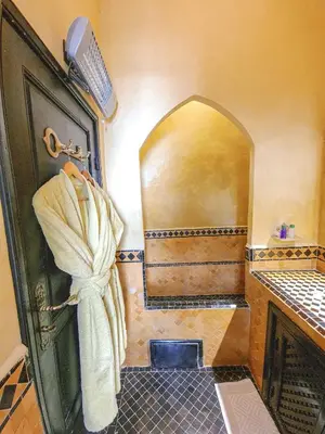 a bathroom with a shower with a towel on the door at Riad Jaime in Marrakech