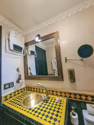 a bathroom with a sink and a mirror at Riad Jaime in Marrakech