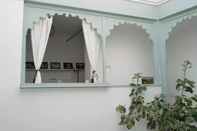 a mirror in a white room with a plant at Riad Nadara, superbe riad au coeur de la medina! in Marrakech