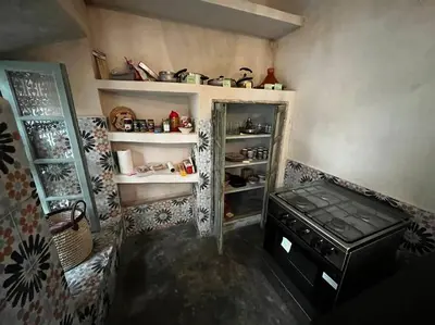 a small kitchen with a stove and shelves at Riad Nadara, superbe riad au coeur de la medina! in Marrakech