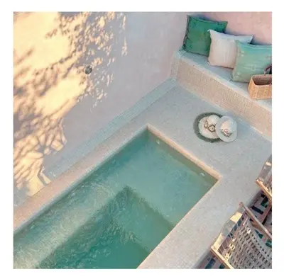 a bath tub with a pool of water in it at Riad Casa nomad in Marrakech