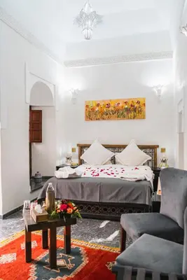 a hotel room with a bed and a couch at Palais Aix Kabaj &Spa in Marrakech
