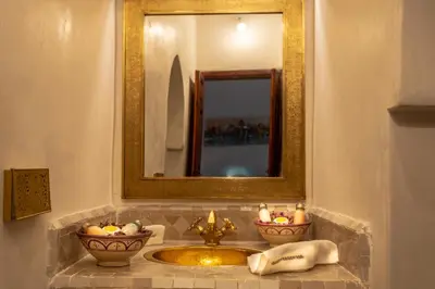 a bathroom with a sink and a mirror at Palais Aix Kabaj &Spa in Marrakech