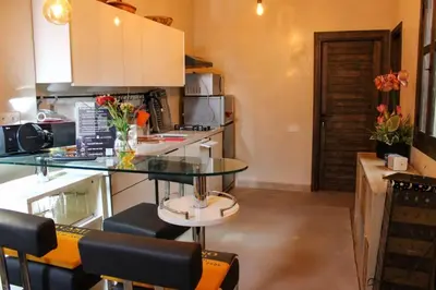 a kitchen with a counter with a glass table at Atypique appart proche J. El fna in Marrakech