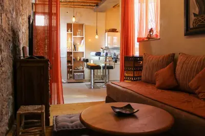 a living room with a couch and a table at Atypique appart proche J. El fna in Marrakech