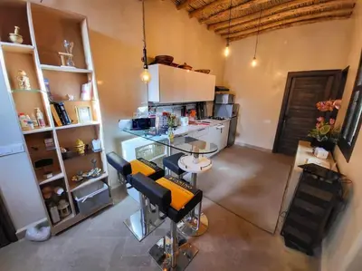 a room with a kitchen with a table and chairs at Atypique appart proche J. El fna in Marrakech