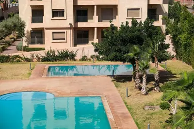 an overhead view of a swimming pool in front of a building at Magnifique appart vue piscine in Marrakech