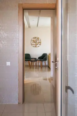 an open door to a room with a table and chairs at Magnifique appart vue piscine in Marrakech