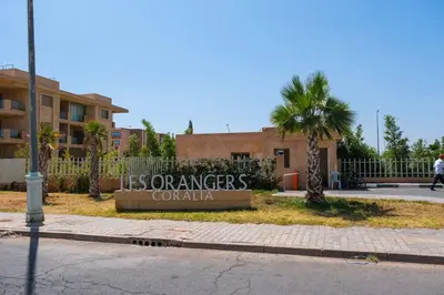 a building with a sign that reads its companies columbia at Magnifique appart vue piscine in Marrakech