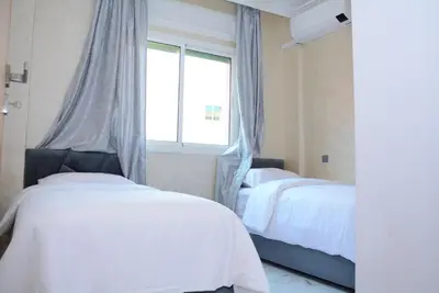 a bedroom with two beds and a window at apartment Marrakech, gueliz in Marrakech