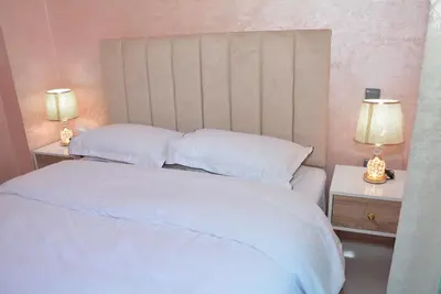 a bedroom with a white bed with two lamps at apartment Marrakech, gueliz in Marrakech