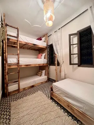 a bedroom with two bunk beds and a chandelier at Peekaboo Hostel in Marrakech