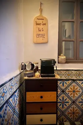 a kitchen with a counter and a sign that reads forever love im a coffee at Peekaboo Hostel in Marrakech