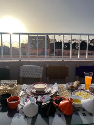 a table with bowls and plates of food on it at Peekaboo Hostel in Marrakech
