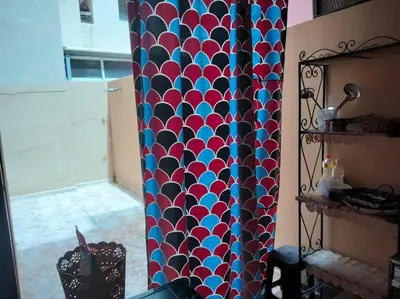 a colorful curtain in a room with a window at les porte de guiliz appartement in Marrakech