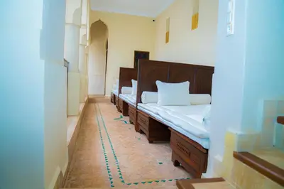 a room with a row of beds in it at Riad Dar Zaouia in Marrakech